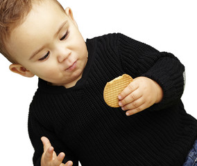 portrait of handsome kid eating a biscuit against a white backgr