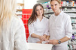 © Tyler Olson - Pharmacists with Customer at the Counter