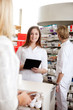© Tyler Olson - Female Pharmacist Holding Tablet Pc