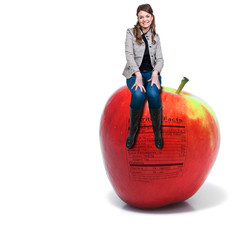 Wall Mural - Woman Sitting on Red Delicious Apple with Nutrition Label