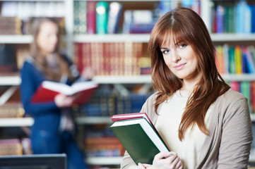 Canvas Print - young student girl study with book in library