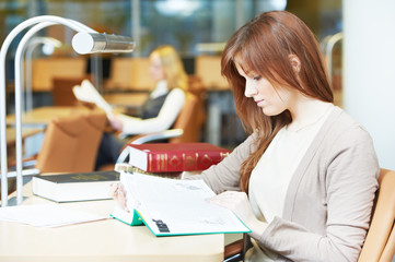 Canvas Print - young student girl study with book in library