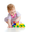 © Andrey Kuzmin - Cute little boy is playing with colorful train isolated on white
