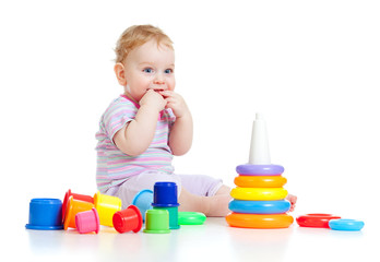 Fototapete - Cute little boy playing colorful toys isolated on white
