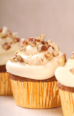 Delicious carrot cake cupcake with cream cheese frosting and nut