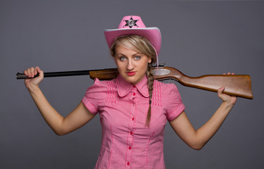 Attractive cawbow girl with shot gun over back