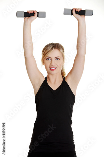 Plakat Młody atrakcyjny żeński ćwiczenie używać dumbbell