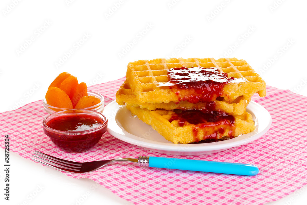 Tasty waffles with jam on plate isolated on white