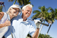 Happy Senior Man & Woman Couple Playing Golf