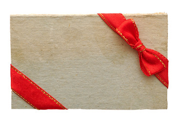 old paper sales tag and label with red ribbon and bow on white b