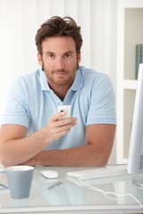 Wall Mural - Portrait of man with cellphone handheld