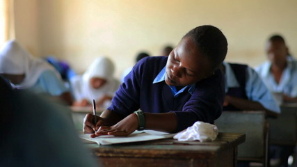 Wall Mural - Students taking a test in a class in a school in Africa.