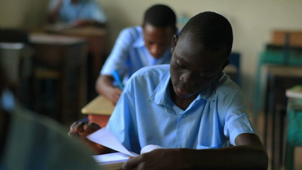 Wall Mural - Students taking a test in an African school.