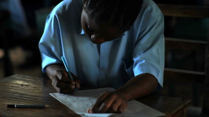 Wall Mural - Students test taking in a class in a school in Africa.
