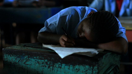 Wall Mural - Students test taking in a class in Africa.