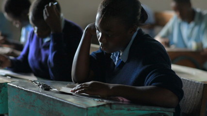 Wall Mural - Students taking an exam in class in a school in Kenya.