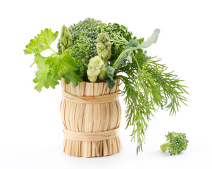 Wall Mural - Bouquet of broccoli, asparagus, dill, parsley in wicker basket