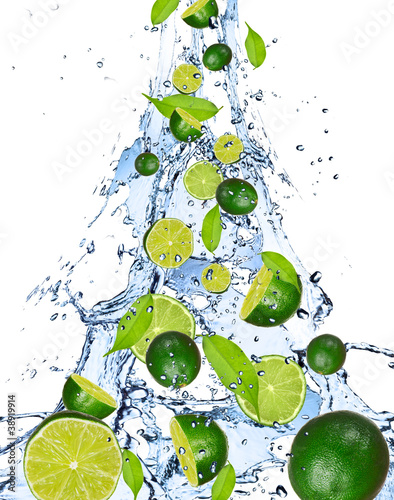 Naklejka dekoracyjna Limes falling in water splash, isolated on white background