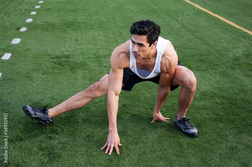 Fotografie, Obraz Handsome, young latino athlete stretching