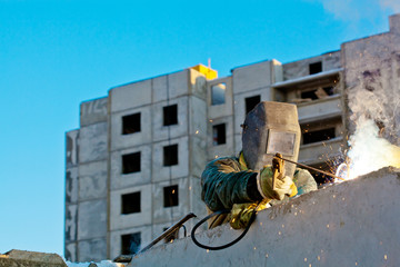 Industrial worker during installation of house wall panels