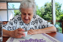 A Senior Fortune Teller With Coffee
