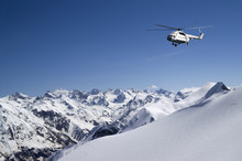 Helicopter In Snowy Mountains