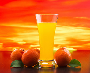 Wall Mural - orange juice in a glass on a table