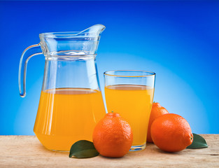 Wall Mural - orange juice in a glass on a table