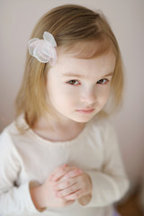 Wall Mural - Adorable little girl with flower hairclip