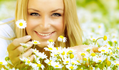 Wall Mural - Beautiful girl enjoying daisy field