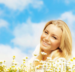 Wall Mural - Beautiful woman enjoying daisy field and blue sky