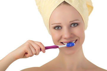 Wall Mural - young healthy woman in a towel cleans teeth with a toothbrush