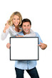 © auremar - Excited couple pointing to a blank sign