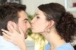 © auremar - woman kissing her boyfriend