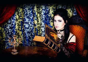 A portrait of the girl in Gothic style with the book in hands