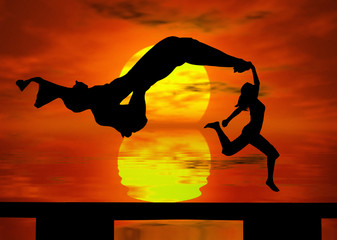 Wall Mural - jumping at the sunset