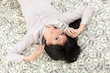 Young business woman resting upon money