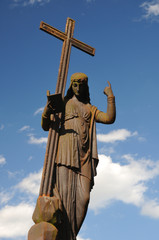 Figure with a cross on blue sky in cemetery Svitavy