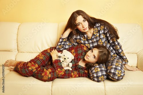 Two Sisters Relaxing On The Sofa Stock Foto Adobe Stock