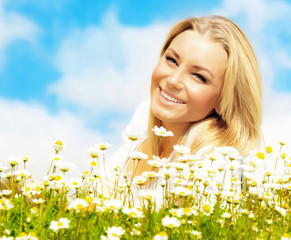 Wall Mural - Beautiful woman enjoying daisy field and blue sky