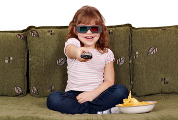 Wall Mural - happy little girl with 3d glasses watching tv