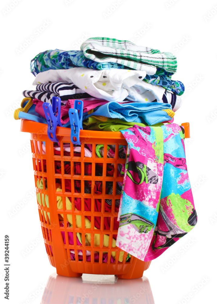 Clothes in orange plastic basket isolated on white