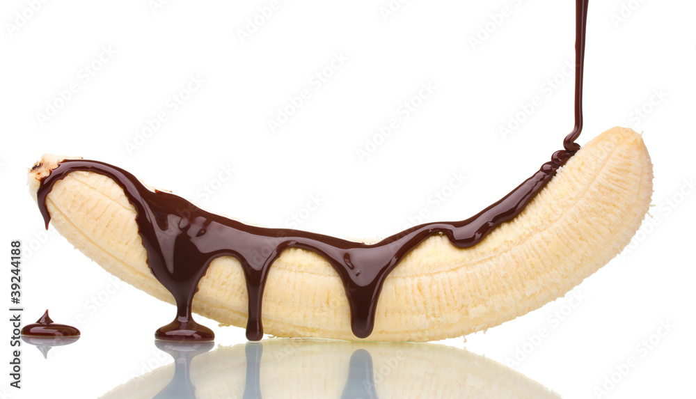 Banana poured with liquid chocolate isolated on white.