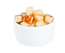 Crouton Stack In A Porcelain Bowl And Scattered Isolated Over Wh