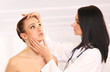 © lenets_tan - Cosmetic medicine, a doctor is examining patient's face
