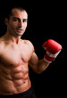 © cristovao31 - Young Boxer fighter over black background