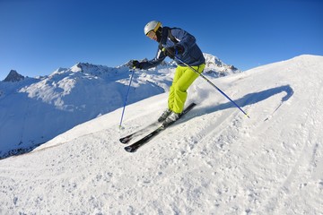 skiing on fresh snow at winter season at beautiful sunny day