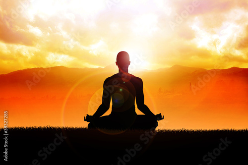 Silhouette of a man figure meditating in the outdoors - 39327285