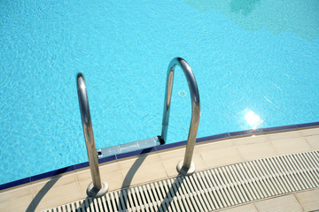 An image of blue swimming pool in summer