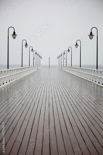 Obraz w ramie old pier in rain on Baltic sea Orlowo Gdynia Poland